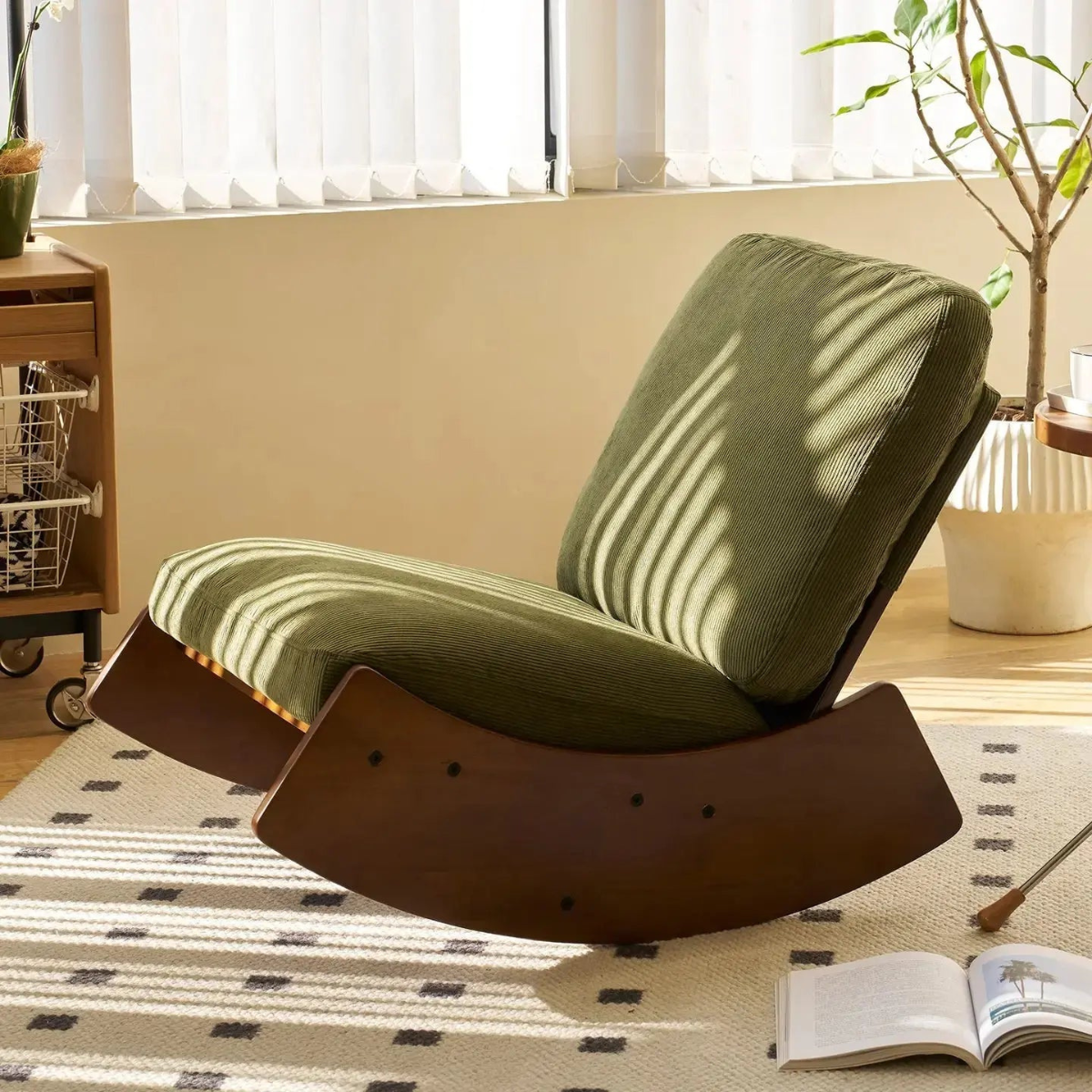 Modern lounge chair in a room with a window, plant, and open book.