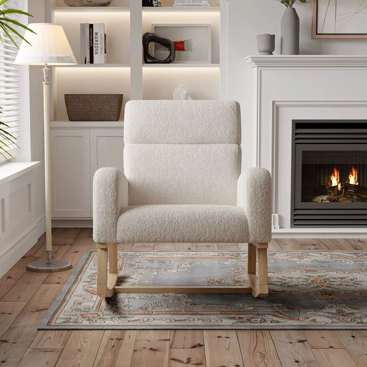 White armchair in a living room with a fireplace and bookshelf.