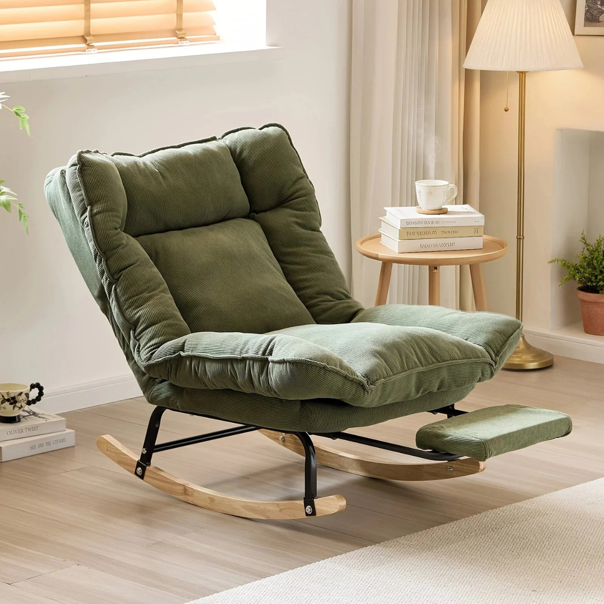 An olive green fabric recliner chair with a footrest and wooden rocking base, styled in a bright, modern living room setting.