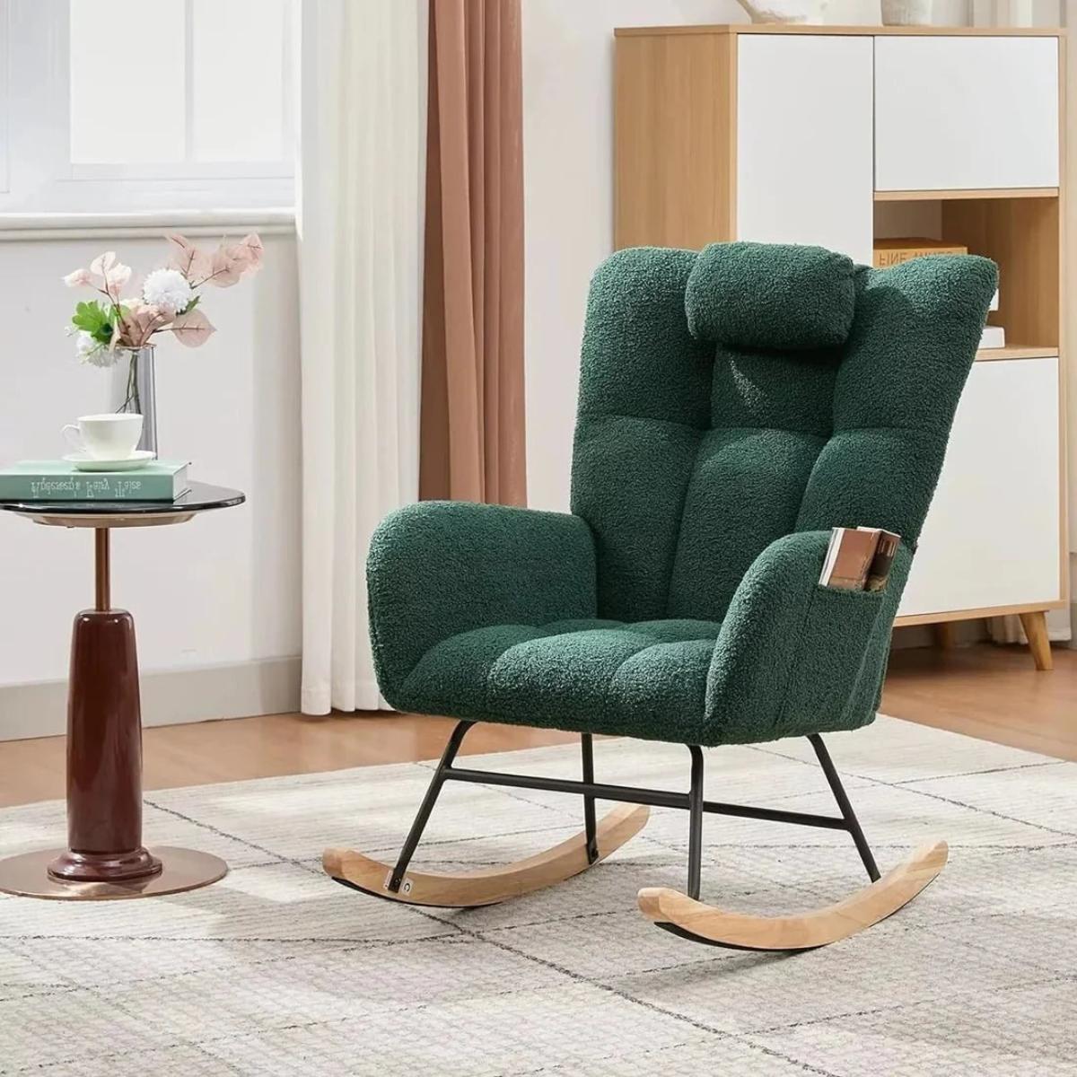 Green rocking chair in a room with a side table and decorative items.
