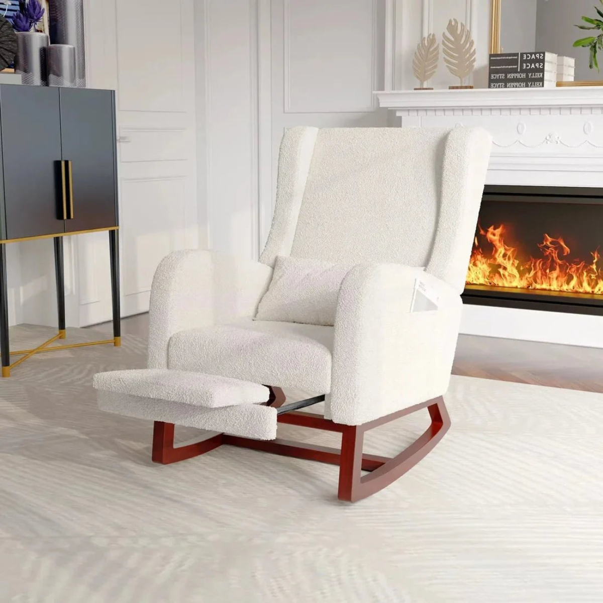 White armchair with wooden legs in a living room setting with a fireplace.