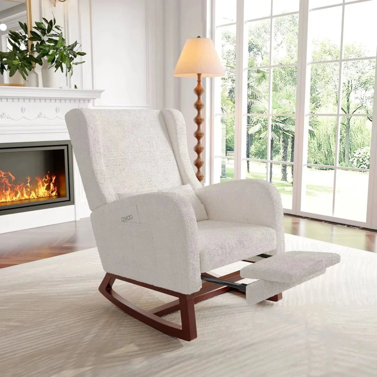 White recliner chair in a living room with a fireplace and large window.