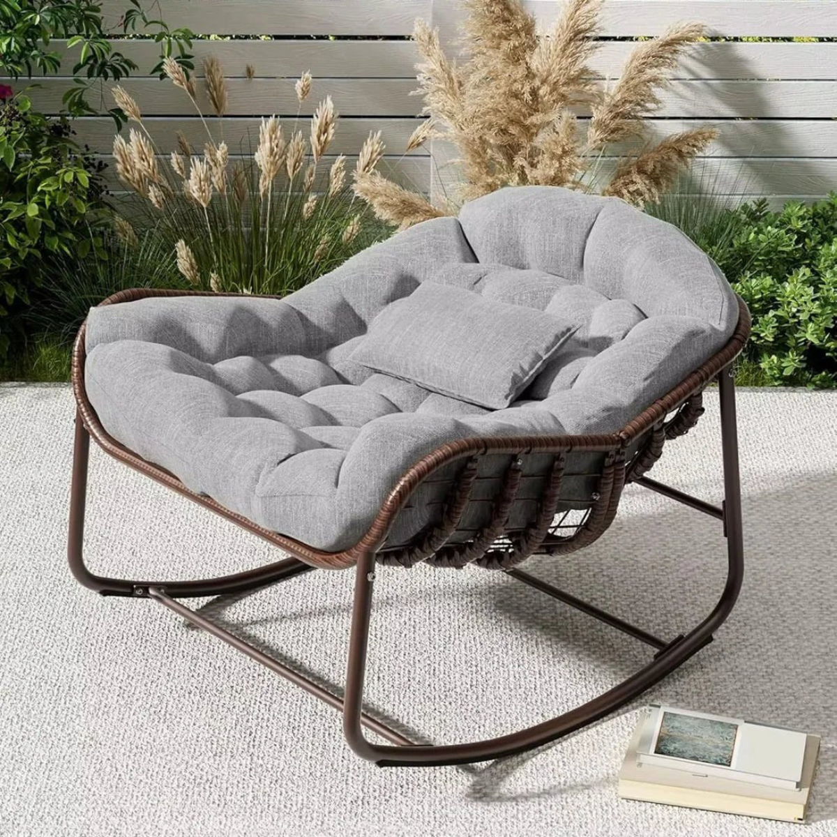 Gray cushioned chair with brown frame on a patio