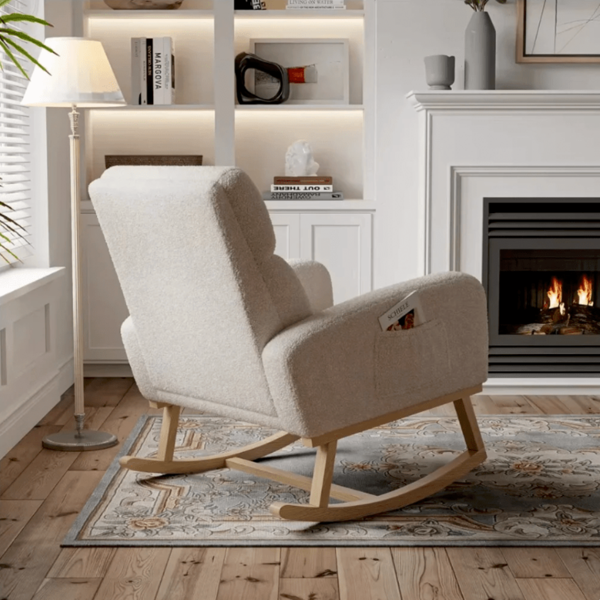 Beige rocking chair in a cozy living room with a fireplace and bookshelf.