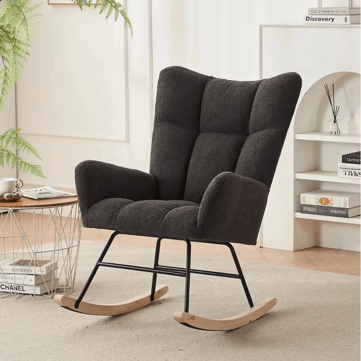 Dark gray rocking chair in a room with a desk and books.