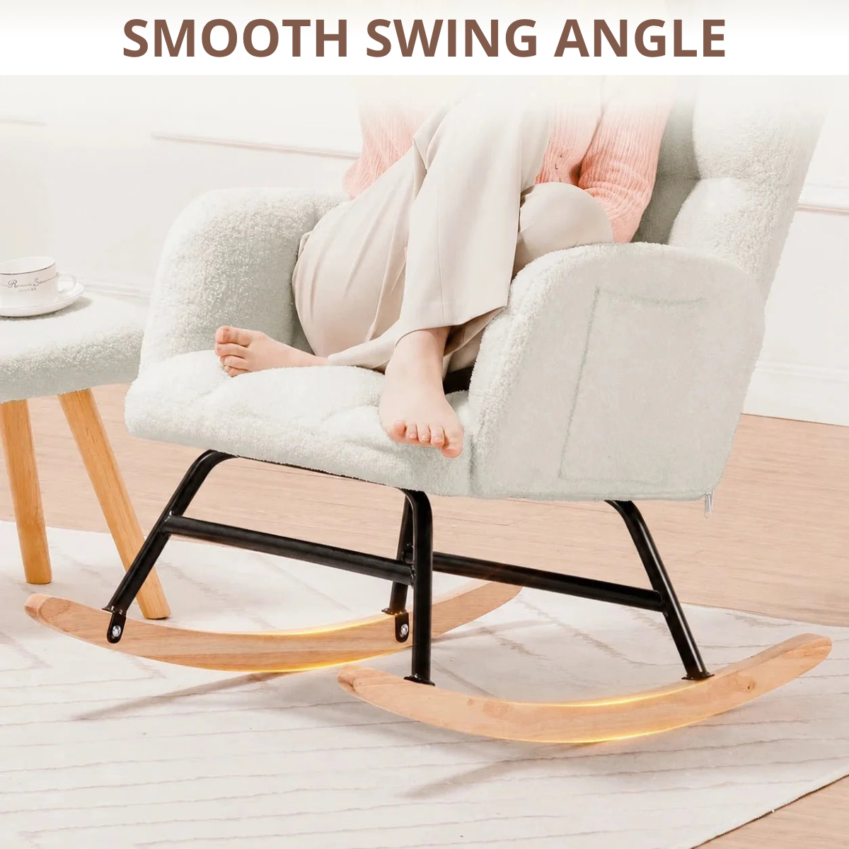 A light beige textured rocking chair with a black metal frame and natural wood rockers, shown with a person sitting on it. The image includes a text overlay at the top reading 'SMOOTH SWING ANGLE'.