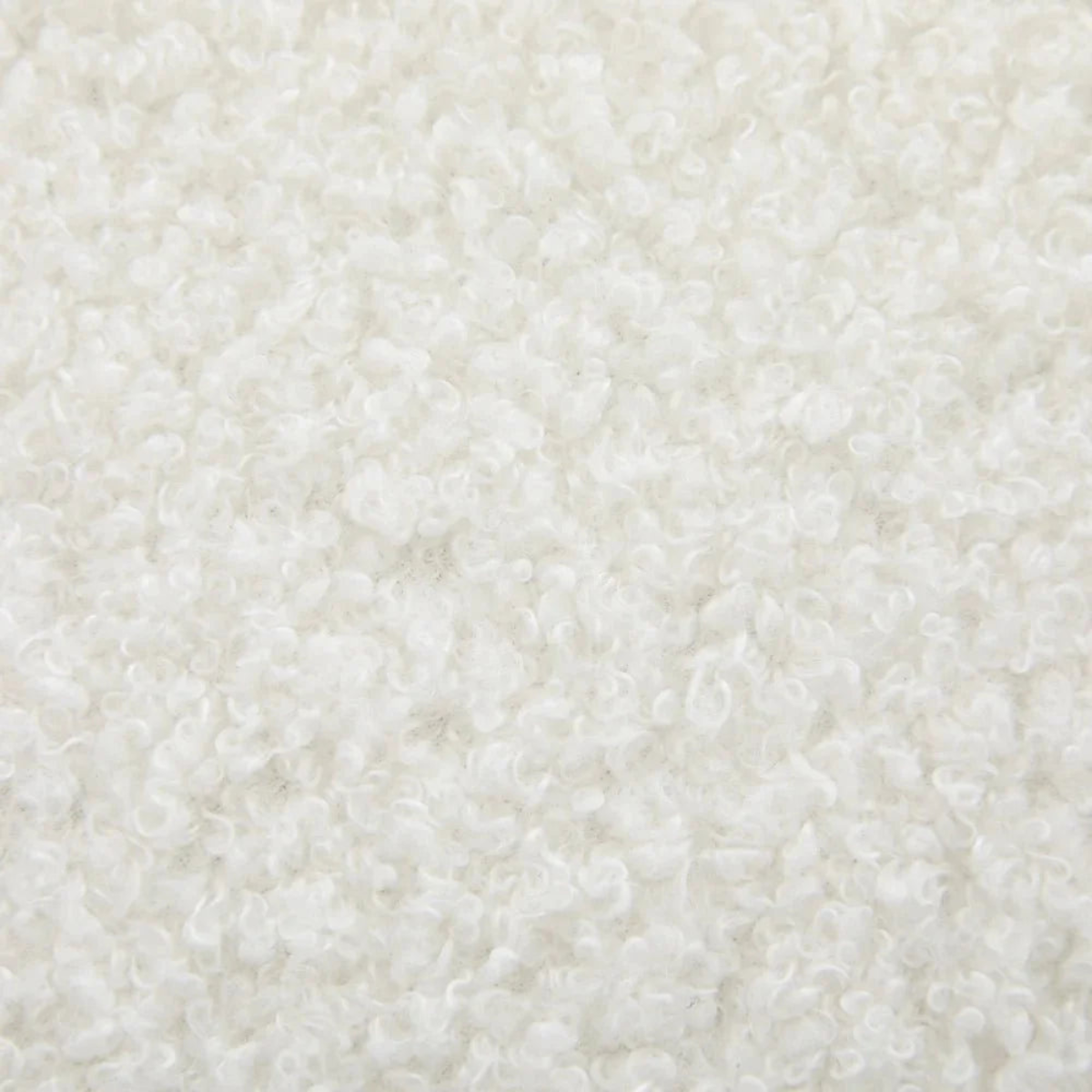 A close-up texture shot of a white curly loop pile fabric, showing the fluffy, curly fibers in detail.